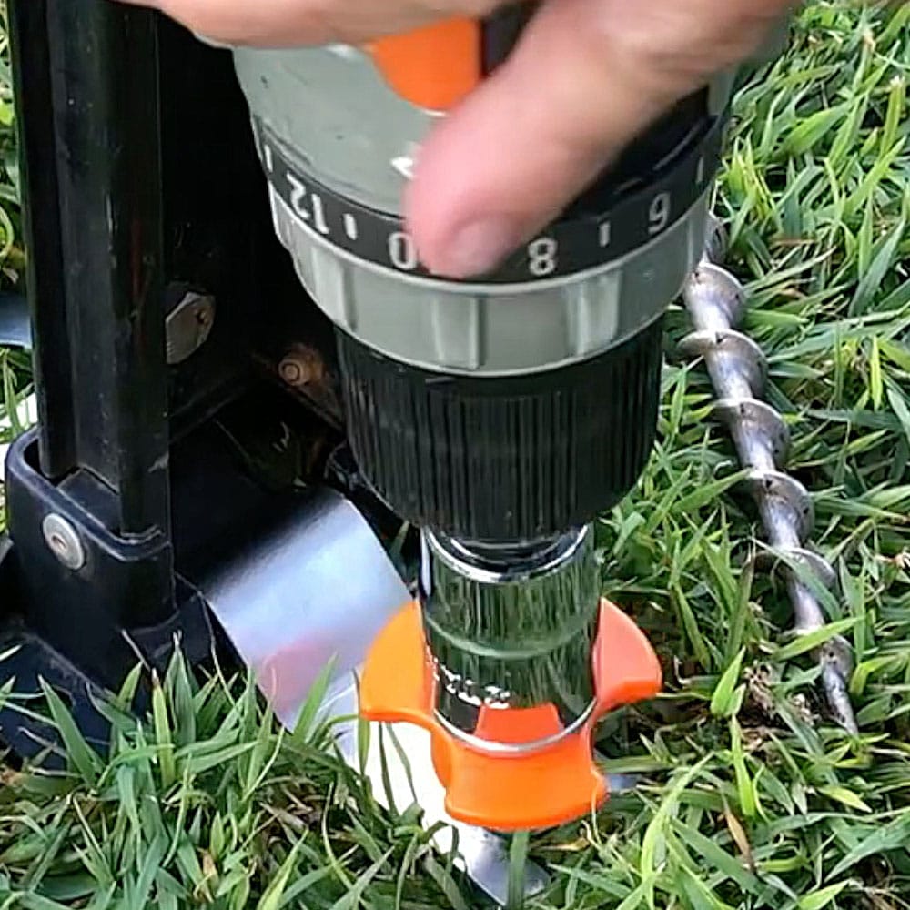 Hand holding Multi Size Socket and Drill Adaptor pressed against the ground