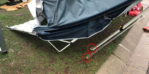 Ground dogs holding tents after storm marked with red circle